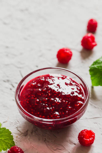 istock homemade raspberry jam on a concrete background with fresh raspberries, selective focus 1283213333