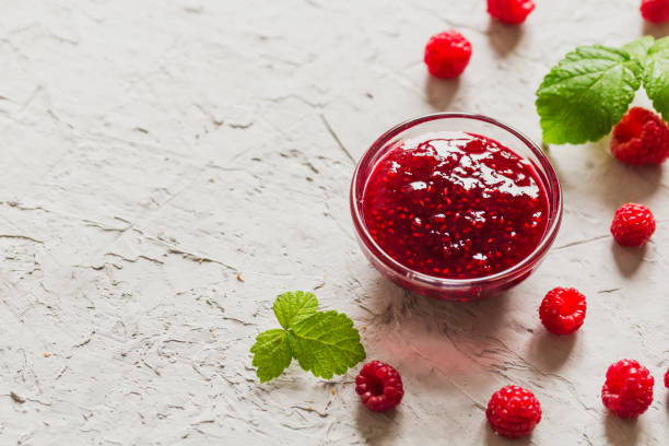 istock homemade raspberry jam on a concrete background with fresh raspberries, selective focus 1283213345
