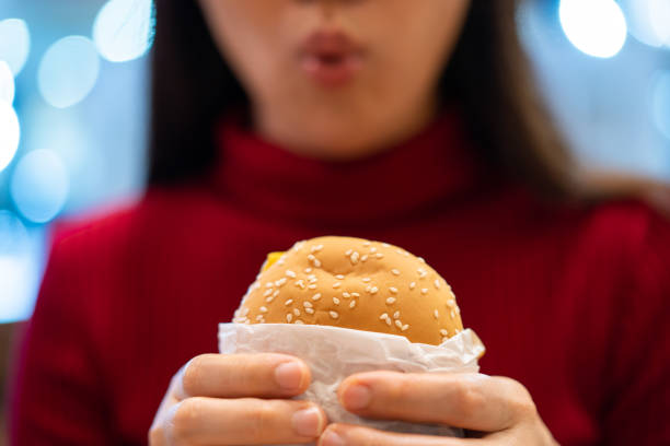 istock Woman enjoy eating a hamburger 1283214242