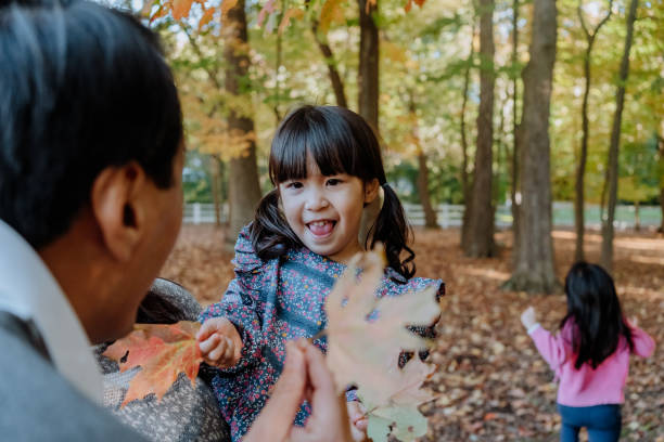 istock Korean father playing with his daughter with maple leafs 1283215630