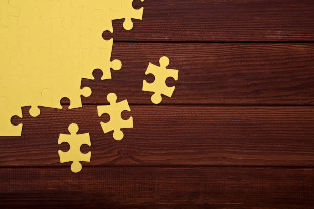 Puzzle on wooden background.Team business concept Puzzle on wooden background.Team business concept coalition building stock pictures, royalty-free photos & images