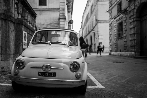 Siena, Italy - September 24, 2020: An old Fiat 500 parking in the old city of Siena