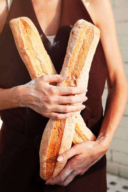 Woman holding fresh bread loaves