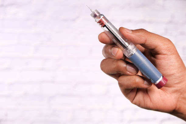 istock hand holding Insulin pens with copy space, Top down 1283218898