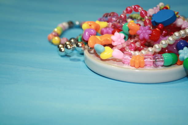 istock Colored decorative beads on a glass transparent saucer 1283219321