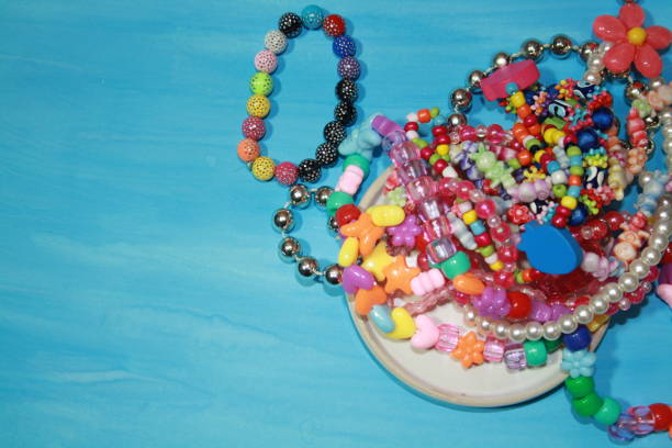 istock Colored decorative beads on a glass transparent saucer 1283219332