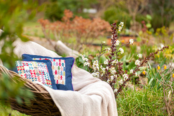 istock Soft luxury home textile set on whicker chair in beautiful garden 1283219964