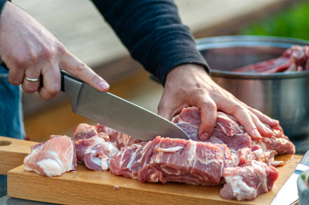 A Chef Slicing Big Piece Of Pork Meat On Wooden Cutting Board Stock Photo -  Download Image Now - iStock