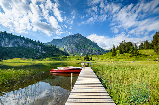 Calm water and reflections at the beautiful lake Koerbersee in Vorarlberg, the most western part of Austria