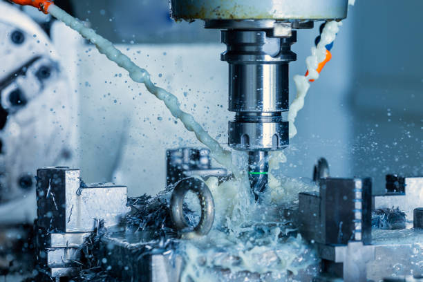 istock vertical cnc steel milling process with external water coolant streams, splashes and a lot of metal chips, high contrast 1283221559