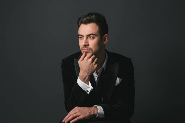 istock Studio portrait of a young man in a tuxedo against plain studio background 1283221597