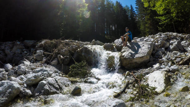 istock Hochturm - A man drinking from a torrent in Austrian Alps 1283221654