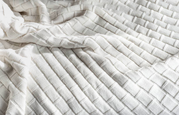 istock White knitted blanket on bed, view from above 1283222301