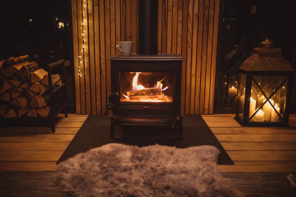 Cozy place for rest Cozy living room winter interior with fireplace firewood photos stock pictures, royalty-free photos & images