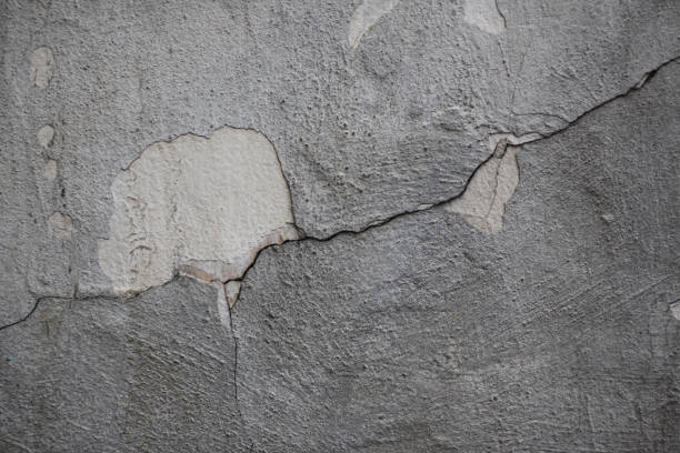 istock Texture of rough plaster on the wall and cracks 1283225709