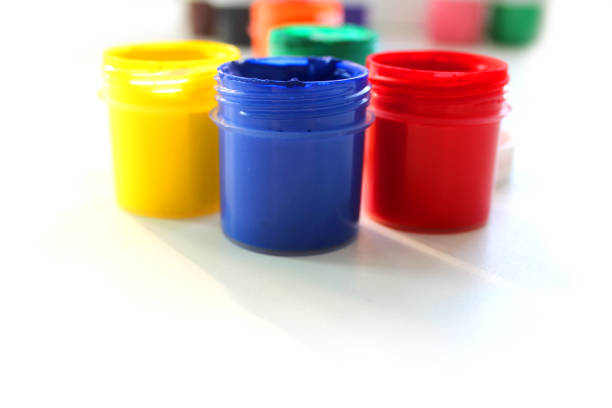 istock Open gouache jars on white background,top view.Copy space.advertising of master classes for painting and drawing lessons 1283229429