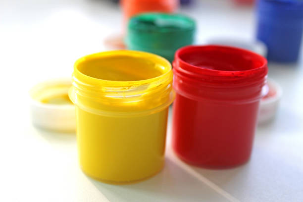 istock Open gouache jars on white background,top view.Copy space.advertising of master classes for painting and drawing lessons 1283229447