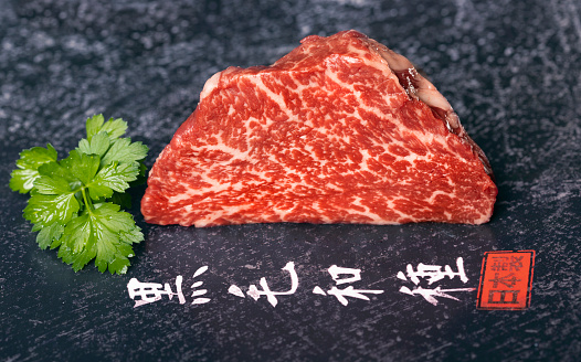Kobe beef filet marbled meat with japanese text on black\nIn Japan, the word \