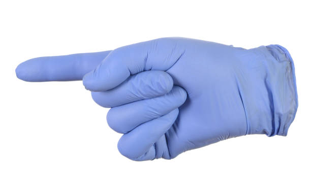 istock Hand in a blue glove, index finger pointing to the left. 1283231702