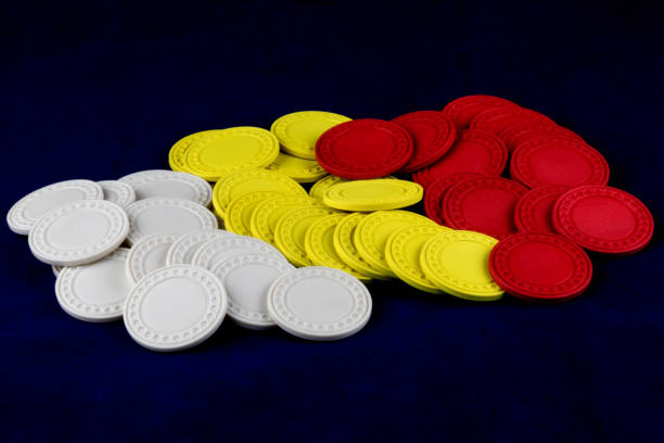 istock Pile of Coloured Gaming Chips on a Blue Background 1283233689