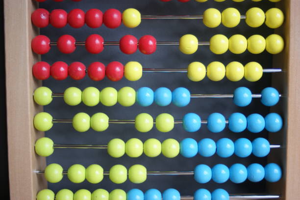 istock calculating with beads on wooden rainbow abacus for number calculation. Mathematics learning concept 1283234640