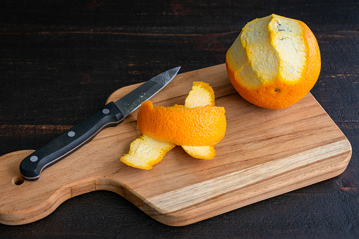 Peeling an orange with a paring knife