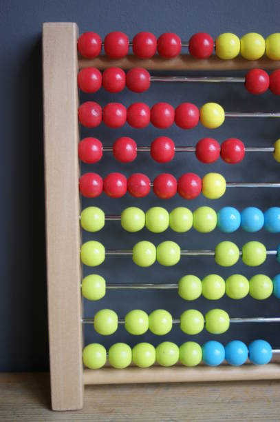 istock calculating with beads on wooden rainbow abacus for number calculation. Mathematics learning concept 1283234676