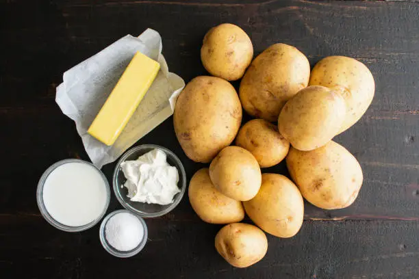 Yukon Gold potatoes, butter, milk, and other ingredients for a traditional side dish
