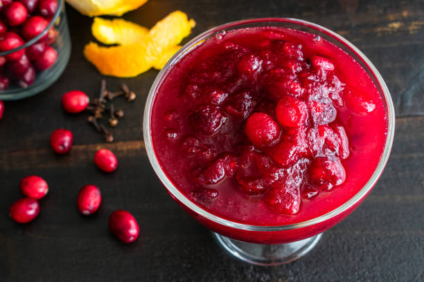 Cranberry Sauce in a Dish Fresh cranberry sauce made with orange peels and cloves compote stock pictures, royalty-free photos & images