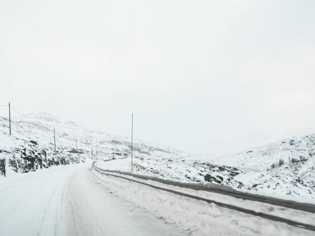 istock Driving through snowy road and landscape in Norway. 1283234853