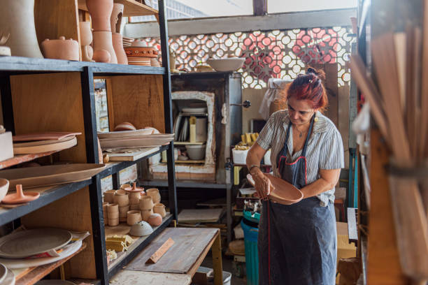 istock Cheerful mature woman working in ceramic workshop 1283234889