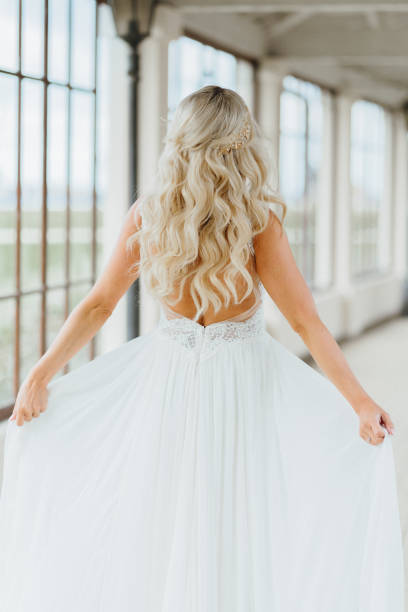 happy pretty bride showing her wedding dress from her back. wedding and happy moments of a woman - hairstyle love wedding photography imagens e fotografias de stock