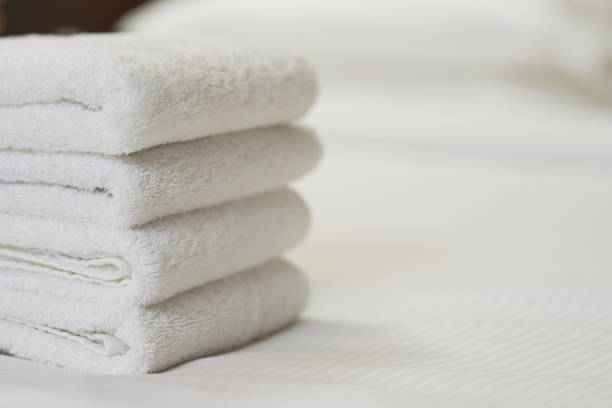 istock Fresh fluffy towels on the bed in apartments 1283239377