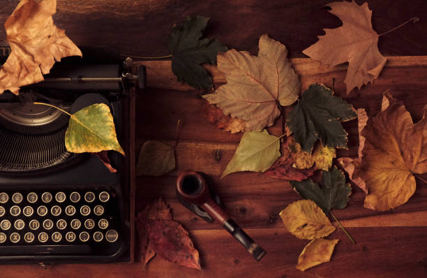 istock Vintage setup with a typewriter on a table with leaves 1283242769