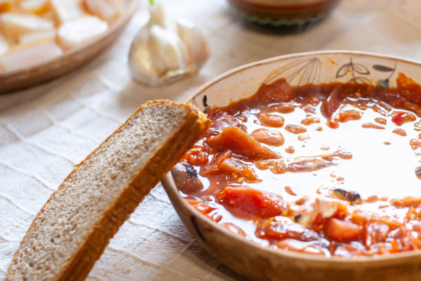 istock Ukrainian borsch served with cream, garlic, salo - on white rustic tablecloth 1283243665