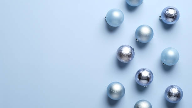 istock Christmas composition in minimal style. Shiny balls decoration on blue background. Top view with copy space. Flat lay. Christmas banner mockup, header, greeting card template. 1283245544