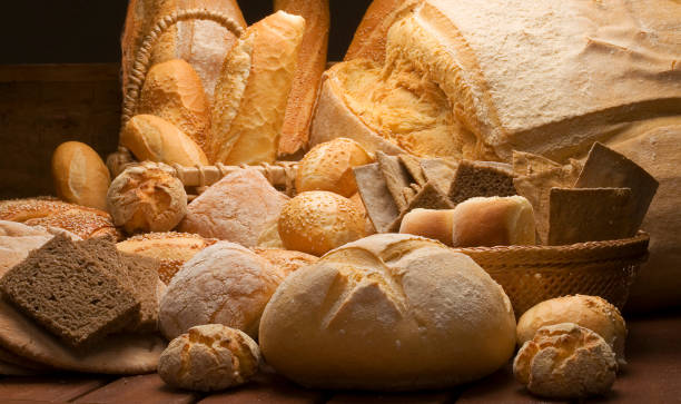 table decorated with various artisan breads produced with studio light. stock photo