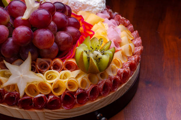 istock cold cuts decorated with ham, salami, sliced turkey breast and fruit. 1283247434