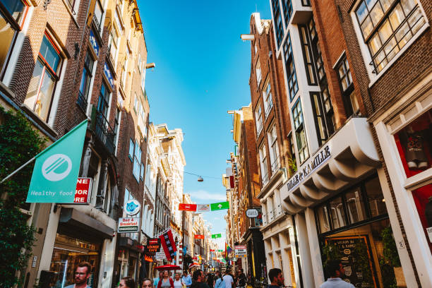 August 1st, 2020 – Amsterdam, Netherlands: Even during the Coronavirus, Amsterdam is still full of tourists and people on the street Nieuwendijk as you can see here in summer 2020.