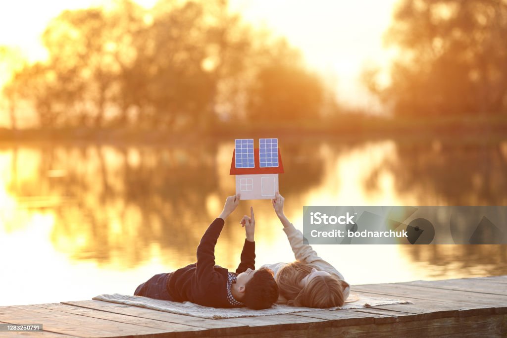 Glückliches Kinderpaar träumt von einem Haus mit Sonnenkollektoren - Lizenzfrei Sonnenkollektor Stock-Foto