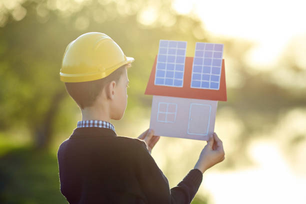 istock Boy dreams of a house with solar panels 1283250859