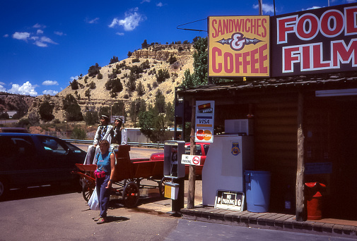 Flagstaff, Arizona, USA - jul 1995: A rustic gas station with convenience store is located along the road into Flagstaff. Everything is very touristy and a bit kitschy.