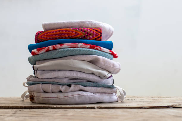 istock Many cloth masks folded and stacked on wooden floors. 1283251786