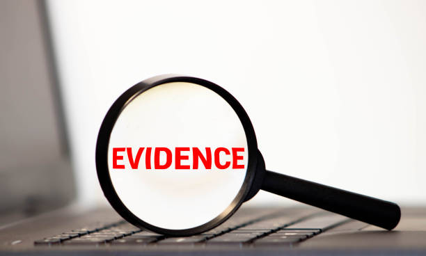 Magnifying glass with the word evidence stock photo