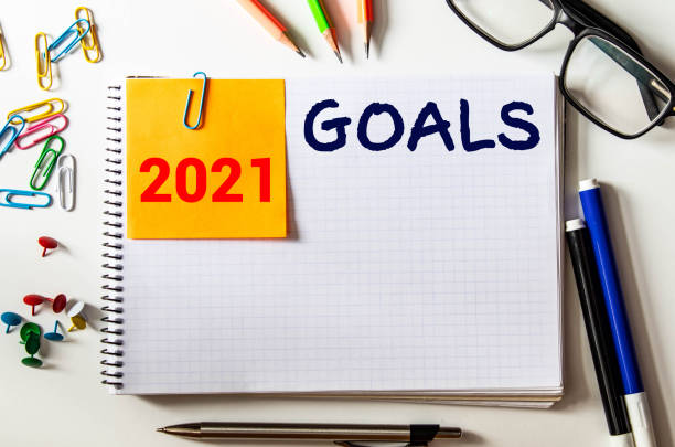 istock 2021 goals text on notebook on wood table. Business motivation, inspiration concept. 1283251875