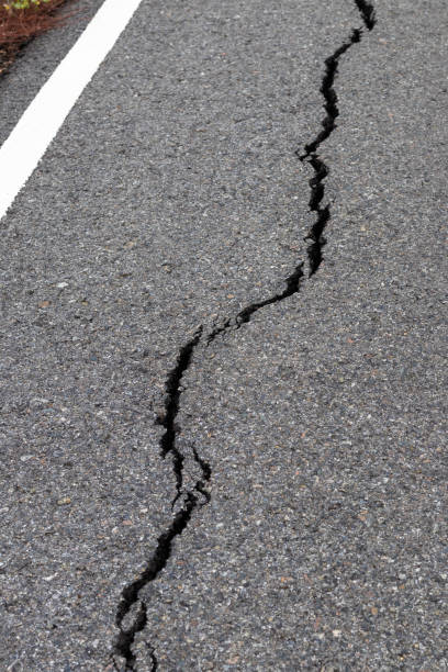 istock Surface cracks paved rural road near the white line. 1283252028
