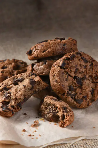 Closeup of a pile of chocolate chocolate chip cookies.