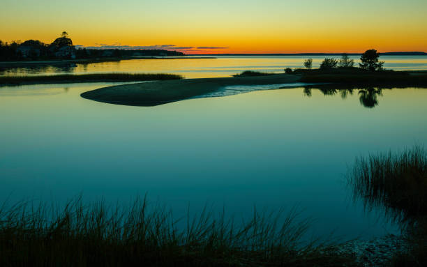 istock Twilight Seascape Silhouette over the Marsh Land at High Tide on Cape Cod in October 1283254235