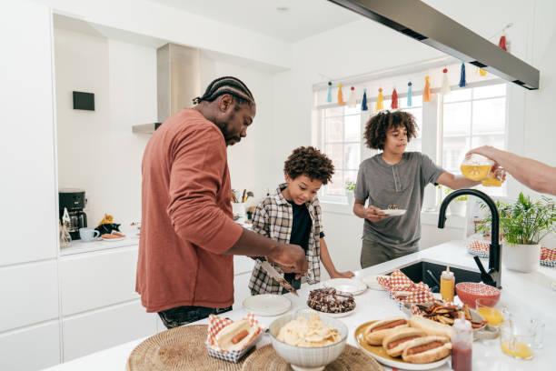 istock Family celebration. Dad cutting the cake in the kitchen 1283257102
