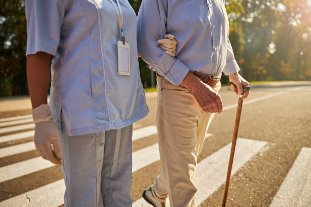 istock Medicine worker helping to the elderly man 1283263610